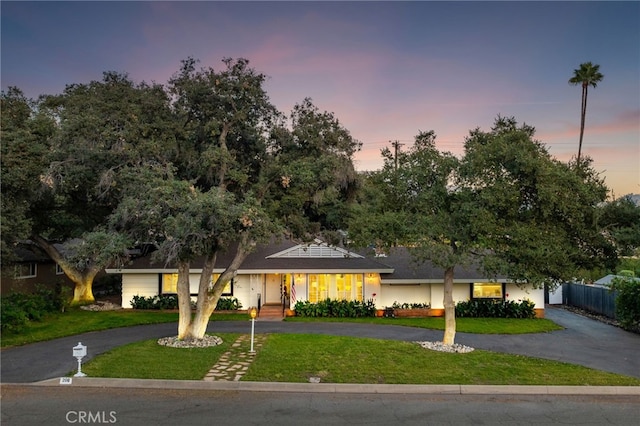 ranch-style home with a yard