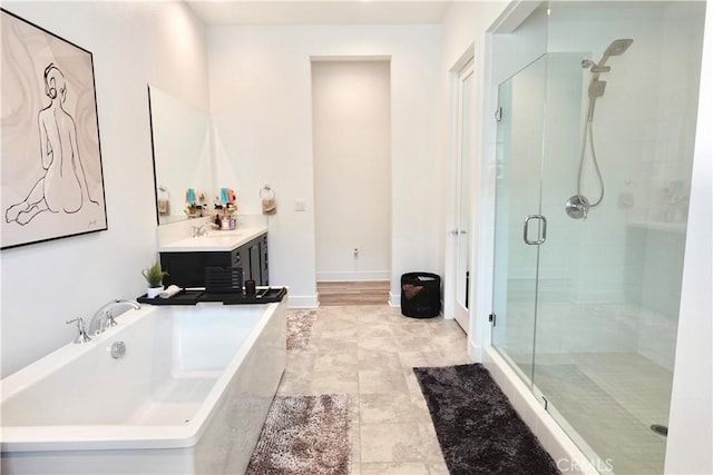 bathroom featuring tile patterned flooring, vanity, and shower with separate bathtub