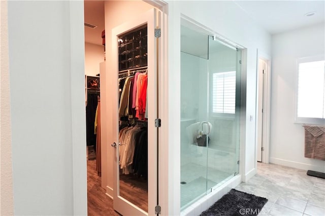 bathroom featuring hardwood / wood-style floors and a shower with shower door