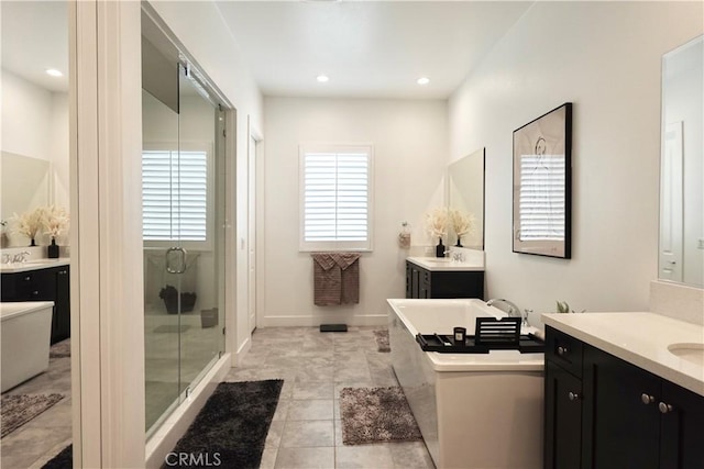 bathroom with shower with separate bathtub, vanity, and tile patterned floors