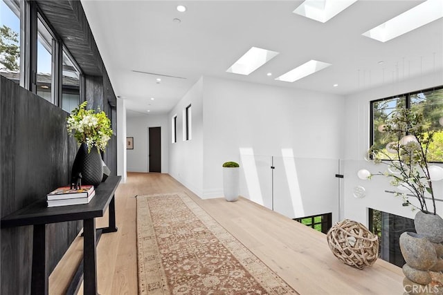 hallway with light hardwood / wood-style flooring