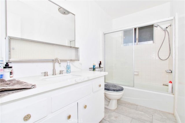 full bathroom with toilet, tile patterned floors, enclosed tub / shower combo, and vanity