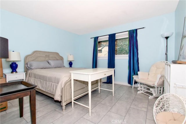 bedroom with light tile patterned floors