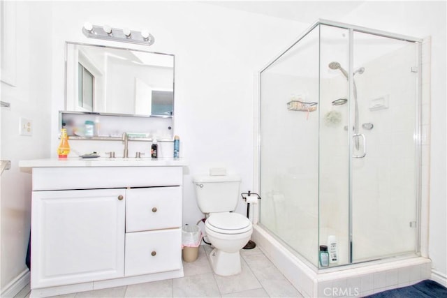 bathroom with toilet, vanity, tile patterned flooring, and a shower with door