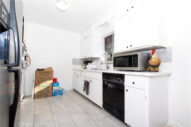 kitchen with white cabinetry, light tile patterned floors, stainless steel appliances, and tasteful backsplash