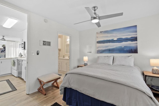 bedroom featuring light wood-type flooring, ensuite bathroom, ceiling fan, and sink