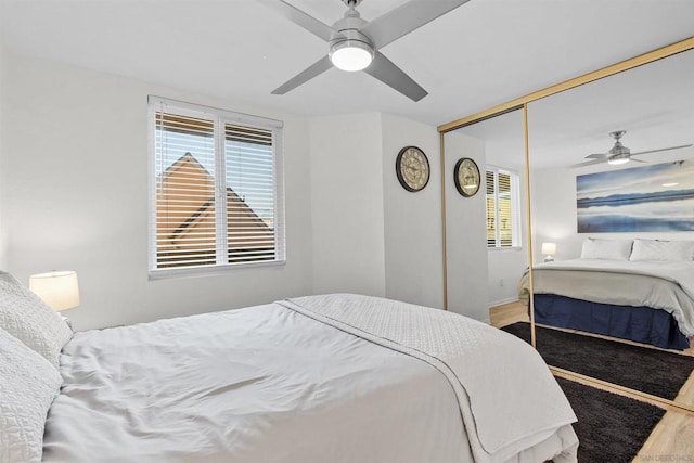 bedroom with ceiling fan, a closet, and wood-type flooring