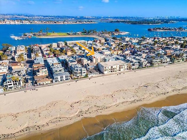 birds eye view of property with a beach view and a water view