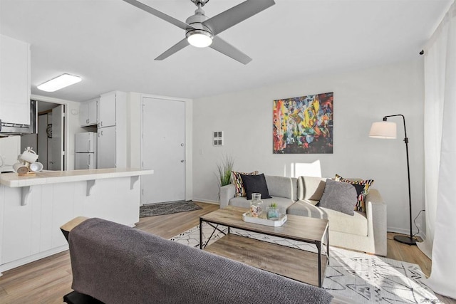 living room featuring light hardwood / wood-style flooring and ceiling fan