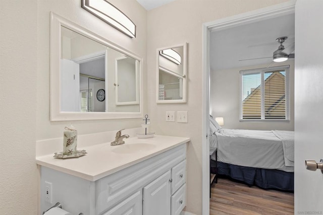 bathroom featuring ceiling fan, vanity, and hardwood / wood-style flooring