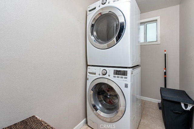1417 W Gage Ave, Los Angeles, CA 90047 - laundry area with stacked washing machine and dryer and light tile patterned floors
