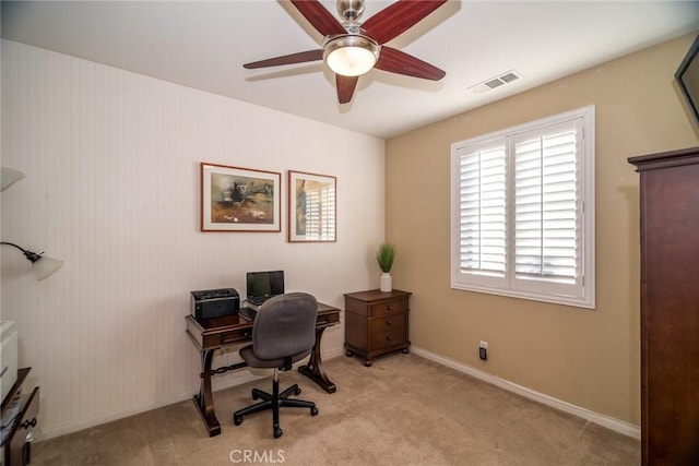 office with light carpet and ceiling fan