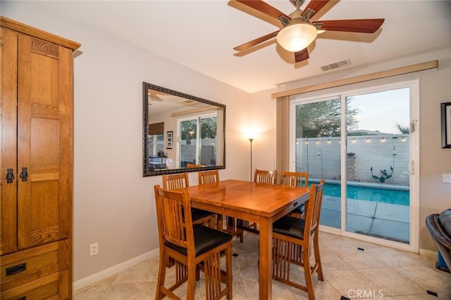 dining area featuring light tile patterned flooring, ceiling fan, and plenty of natural light