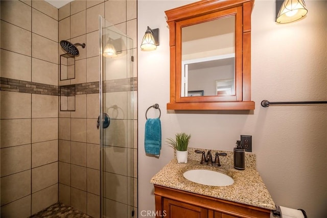 bathroom with vanity and a shower with shower door