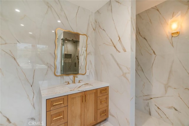 bathroom featuring vanity, a shower, and tile walls