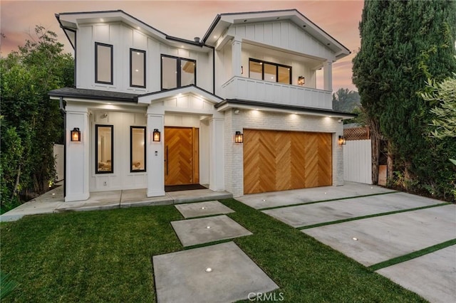 view of front of property with a garage and a yard