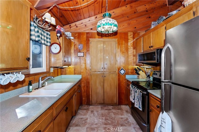 kitchen featuring stainless steel appliances, sink, wooden ceiling, hanging light fixtures, and wood walls