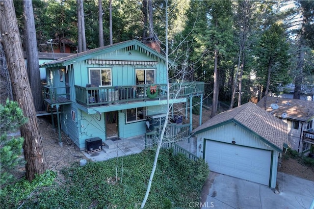 exterior space with a balcony, an outbuilding, cooling unit, a patio area, and a garage