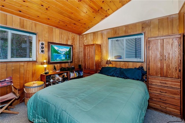 carpeted bedroom featuring wood walls, lofted ceiling, and wood ceiling