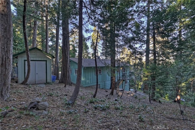 view of property exterior with a shed