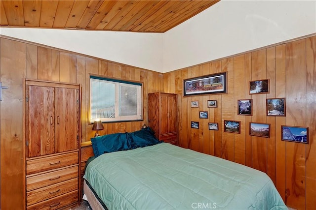 bedroom with wood ceiling, wooden walls, and vaulted ceiling