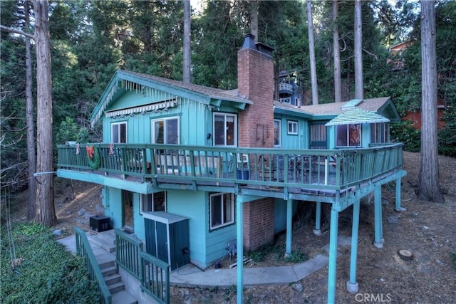 back of property featuring a wooden deck