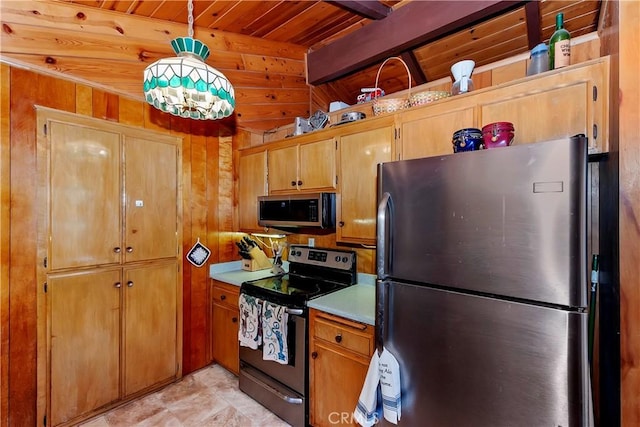 kitchen with wooden ceiling, hanging light fixtures, wooden walls, appliances with stainless steel finishes, and beam ceiling