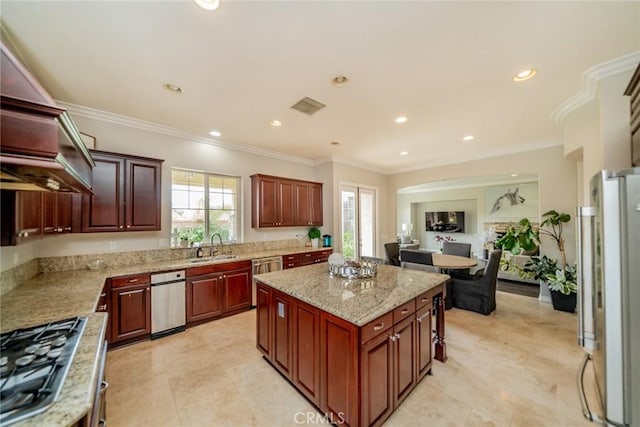 kitchen with crown molding, sink, a kitchen island, and stainless steel appliances