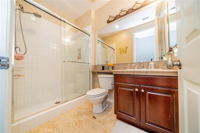 bathroom featuring tile patterned floors, vanity, toilet, and walk in shower