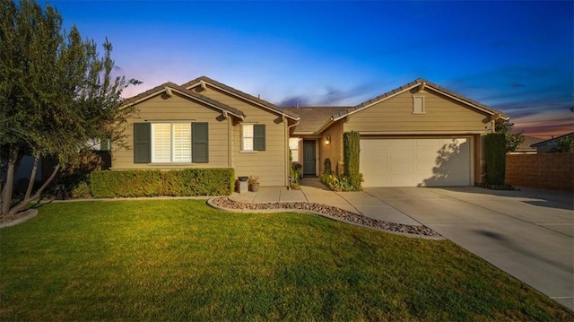 single story home featuring a yard and a garage