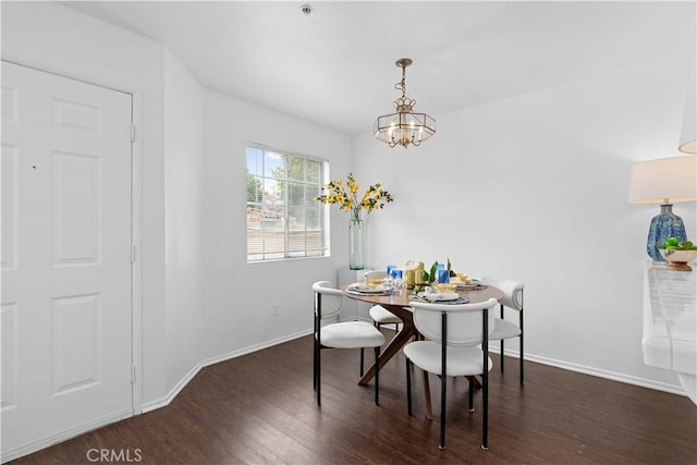 dining area with a chandelier and dark hardwood / wood-style flooring