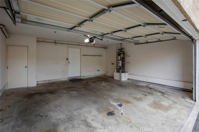 garage with a garage door opener and water heater