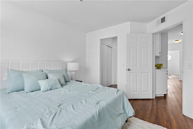 bedroom with dark hardwood / wood-style flooring