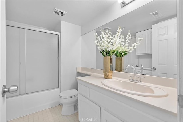 full bathroom featuring vanity, enclosed tub / shower combo, and toilet