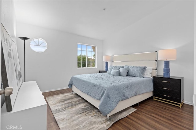 bedroom with dark hardwood / wood-style flooring