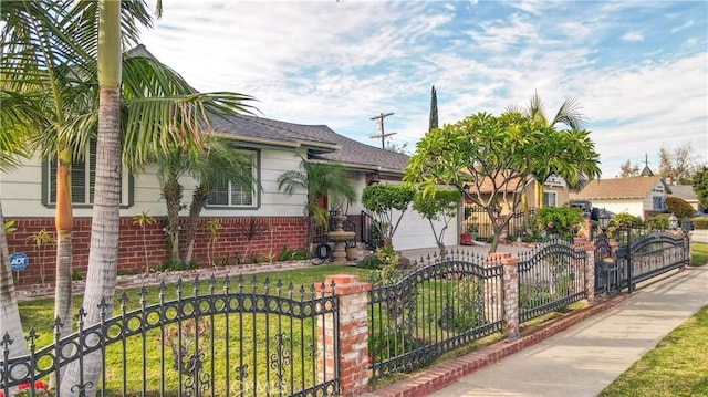 view of front of home with brick siding and a fenced front yard