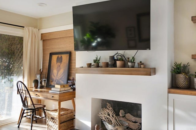 bar with a fireplace and hardwood / wood-style flooring