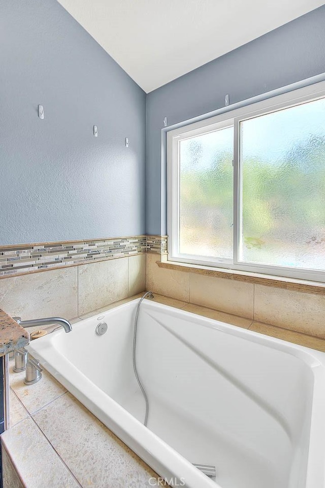 bathroom featuring a tub to relax in and tile patterned floors