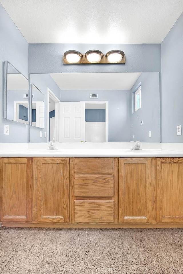 bathroom featuring vanity and a textured ceiling