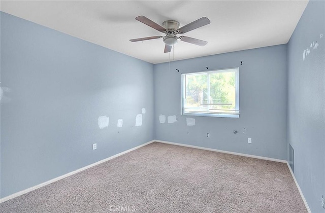 empty room with ceiling fan and carpet floors