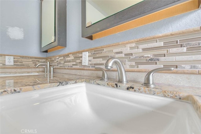 interior details featuring backsplash and sink