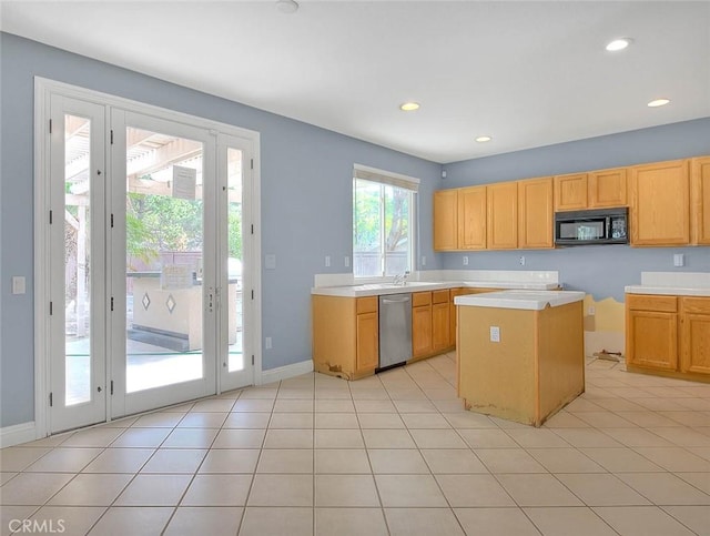 kitchen featuring stainless steel dishwasher, a center island, a healthy amount of sunlight, and light tile patterned flooring