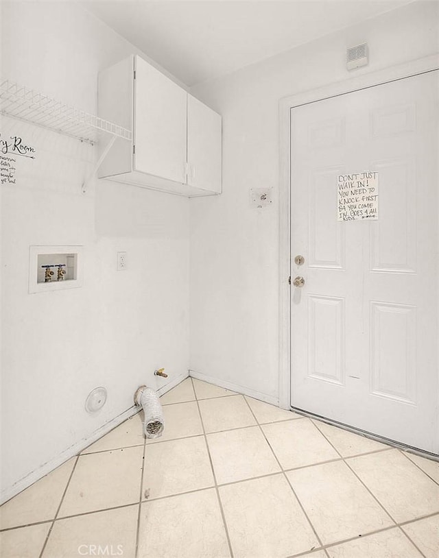 washroom featuring cabinets, hookup for a washing machine, and light tile patterned flooring