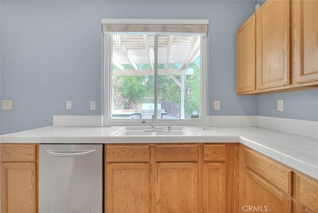 kitchen featuring dishwasher, light brown cabinets, and sink