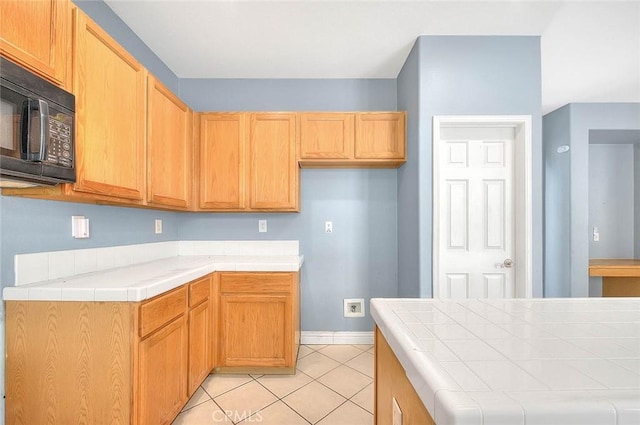 kitchen with tile countertops and light tile patterned floors