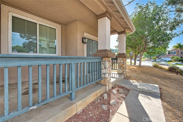 entrance to property featuring covered porch