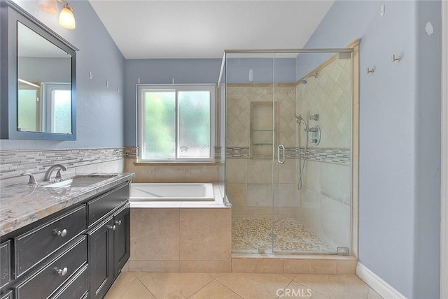 bathroom with tile patterned floors, vanity, and separate shower and tub