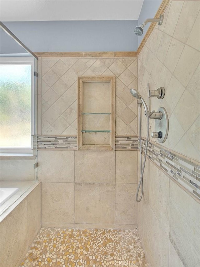 bathroom with tiled shower