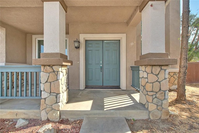 view of exterior entry with covered porch