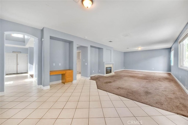 unfurnished living room with light colored carpet